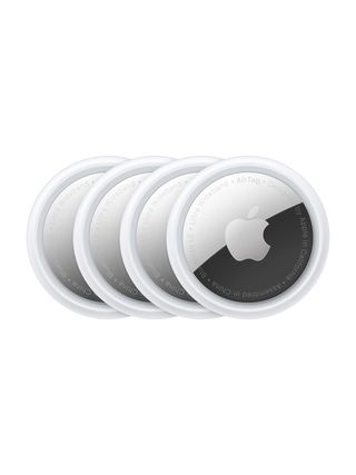 Four Apple AirTag disks stacks on another in a row