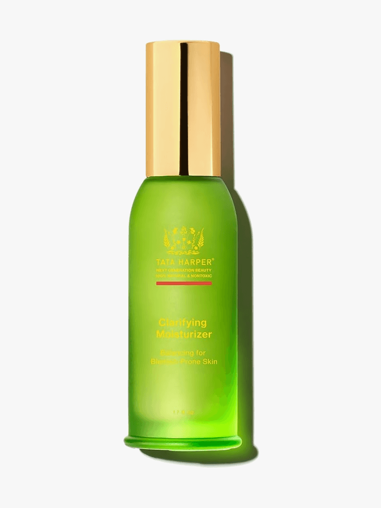 Clarifying Moisturizer in branded green bottle with gold cap on light gray background