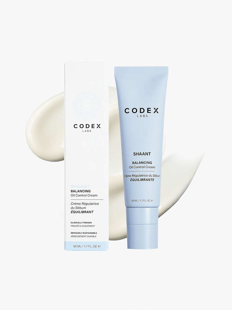 Shaant Balancing Oil Control Cream in branded blue tube next to branded box packaging on top of product swatch on light gray background